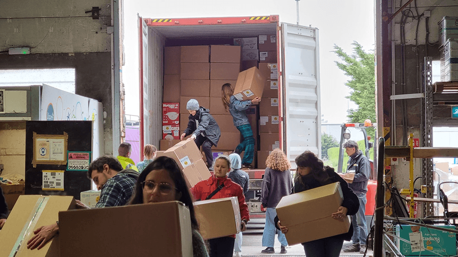 people carrying boxes from a truck