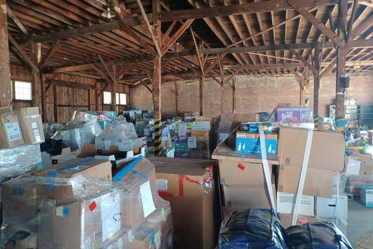 A warehouse filled with lots of boxes of donations