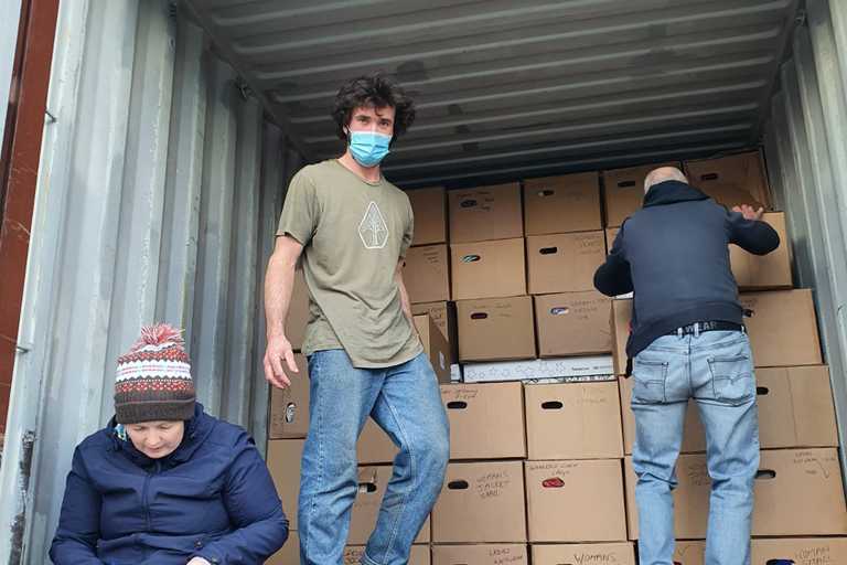 Volunteers loading a truck of boxes of aid items