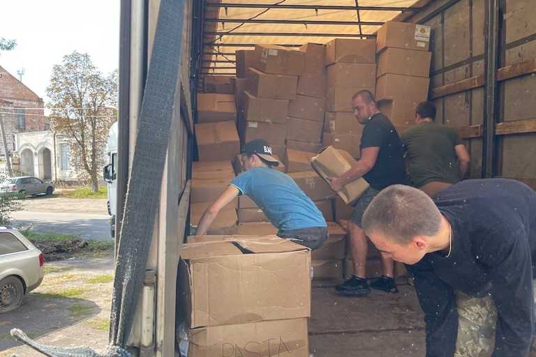 Volunteers unloading a truck full of boxes of donated items